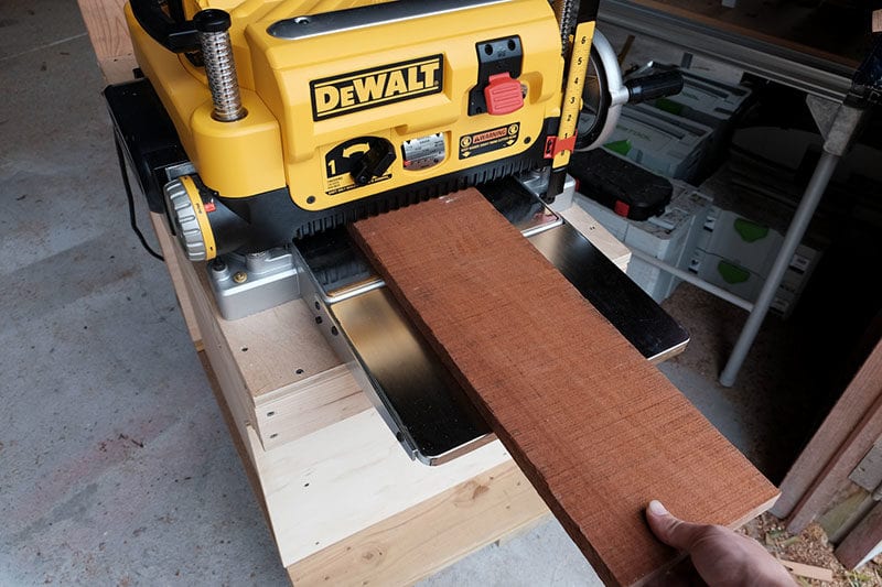 feeding a board into the DeWalt planer